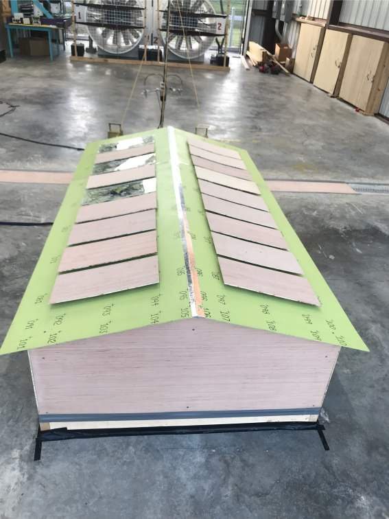 A 1:7.5-scale gable-roof model with rooftop PV panels and pressure taps