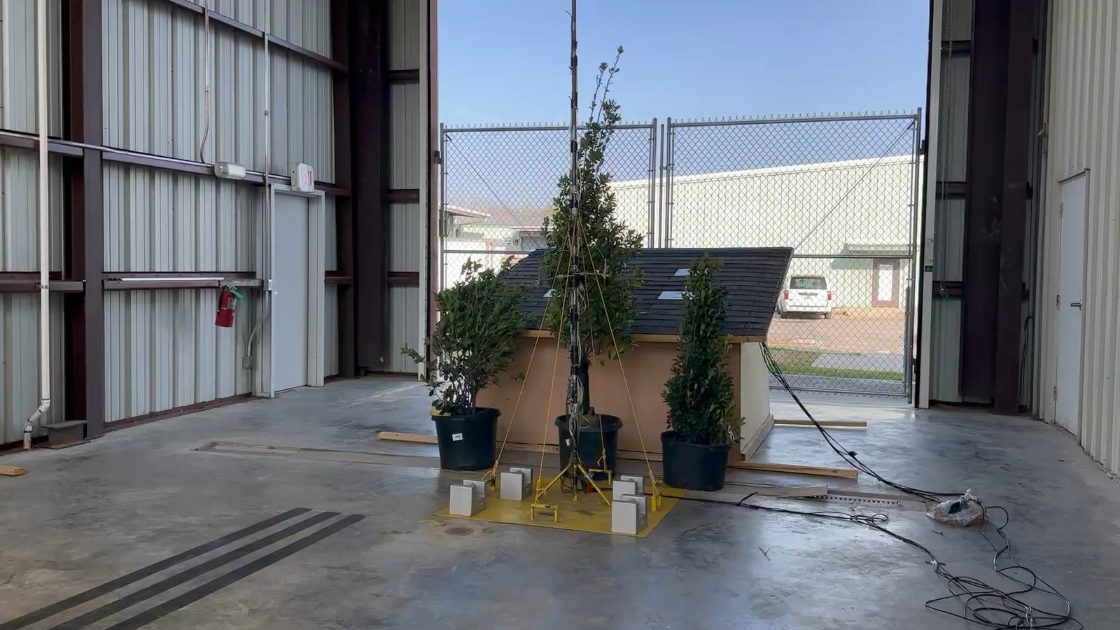 Trees and a solar-roof building model in the open jet
